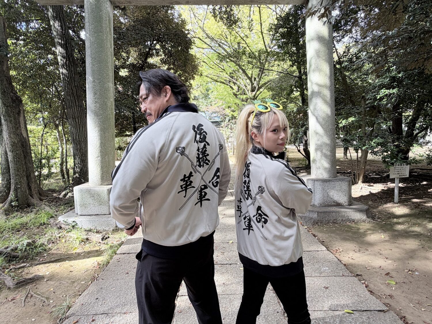 Hirooki Goto and Yuna Mizumori show the backs of their matching jerseys, which have the words "Goto Revolutionary Army" on them